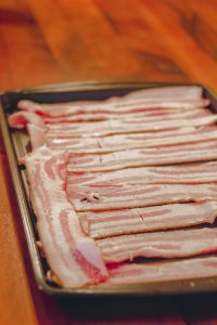 a pan of uncooked bacon