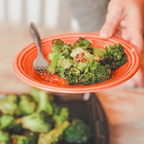 a plate of broccoli being served