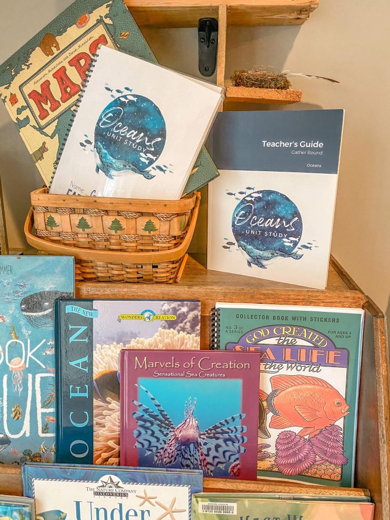 a bookcase with gatheround homeschool oceans unit on top with other oceans books
